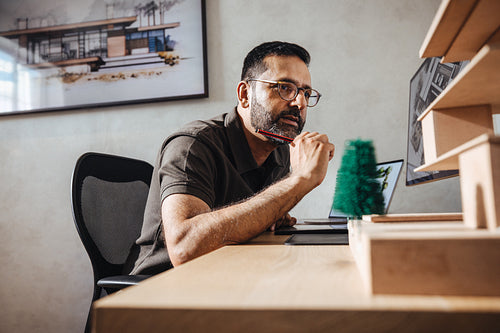 Architect working on a model and design in a modern studio