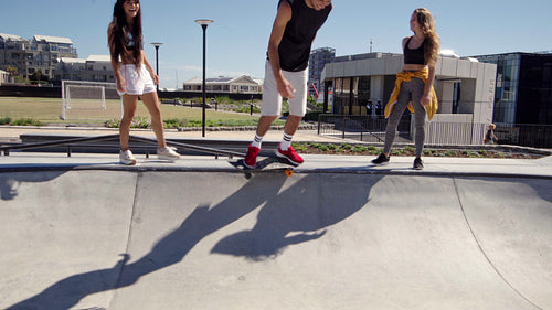 Active young man skating in an urban skate park