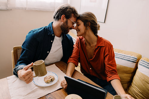 Couple shares coffee and smiles at table