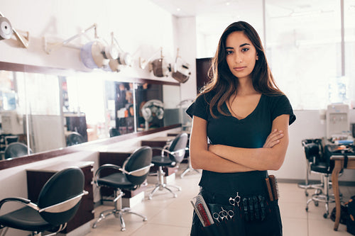 Portrait of female hairstylist looking at camera