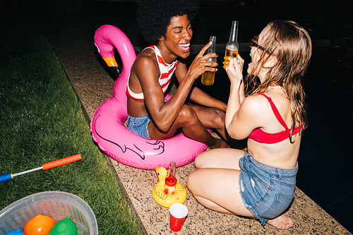 Friends enjoying evening by the pool
