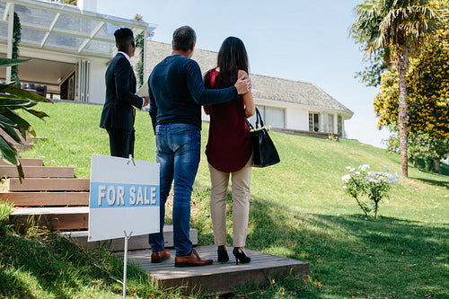 Couple visiting luxury villa with real estate agent