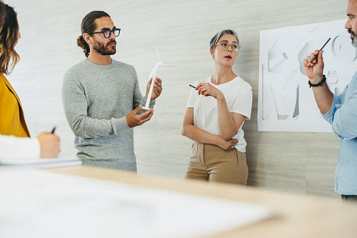 Creative design professionals working on a renewable energy project