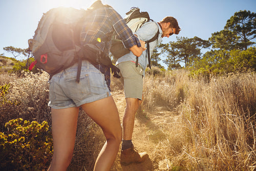 Couple hiking in mountain on a hot sunny day