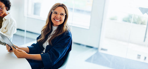 Female ux designer reviews tablet and smiles