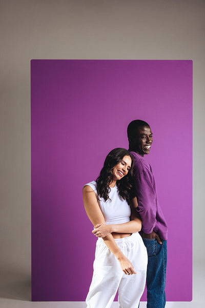 Man and woman standing in a studio wearing casual clothing