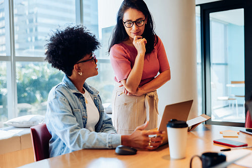 Clarifying the plan: Coworkers reviewing project details