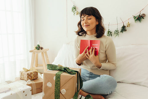Woman cherishing christmas greeting card