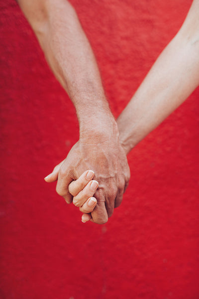 Loving man and woman holding hands