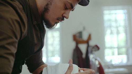 Barber grooming client in salon