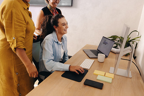 Smiling coworkers collaborating on a project in a modern office workspace