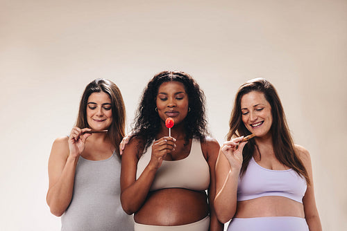 Pregnant women enjoying a yoga class and indulging in sweet cravings