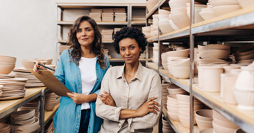 Confident ceramists working together in their shop