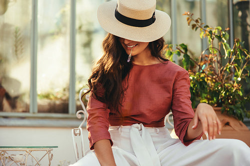 Happy young tourist woman wearing a tipped hat outdoors