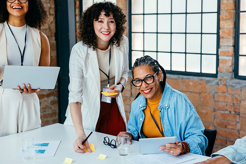 Confident female professionals in business meeting showcasing success, teamwork, and collaboration in modern office setting