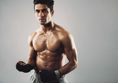 Muscular fitness model on grey background
