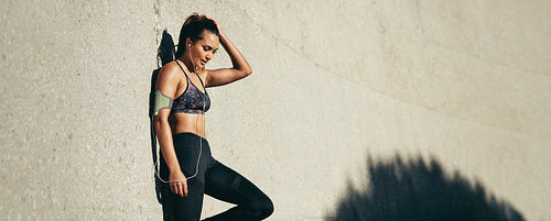 Sporty woman relaxing after running exercise