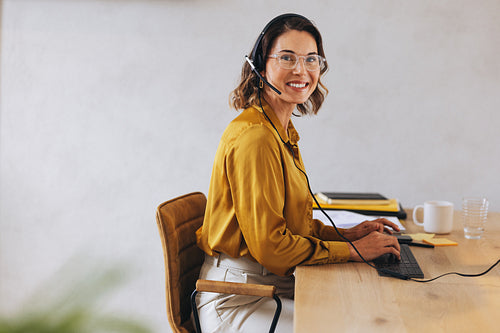Professional call center agent working at her desk