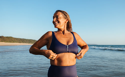Mature and empowered woman enjoying a healthy lifestyle by the seaside
