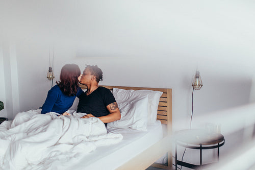 Romantic couple kissing in bed