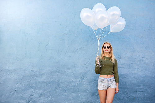 Attractive female fashion model with balloons
