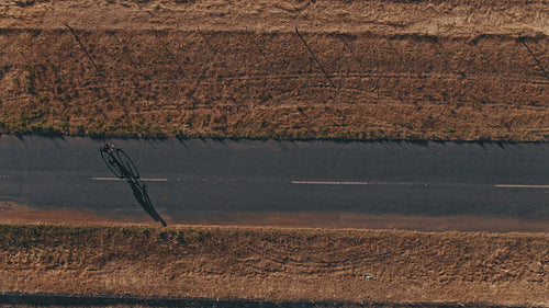 Cyclist riding a bicycle on a countryside road