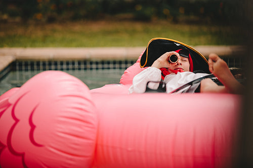 Boy playing pirate in pool