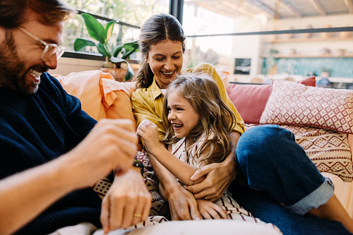 Family laughter on a cozy couch