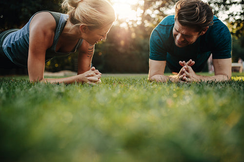 Healthy young couple exercising at park