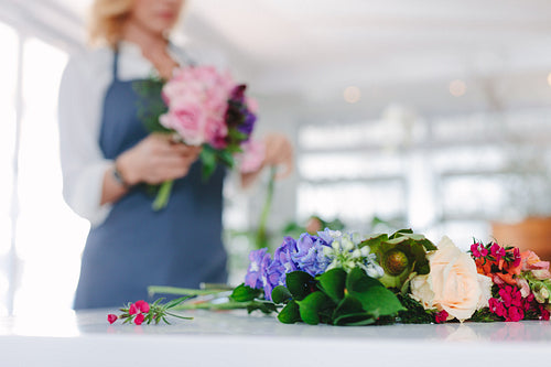 Fresh flower on counter with florist at back