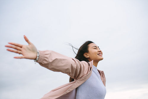Close up of a woman standing with open arms