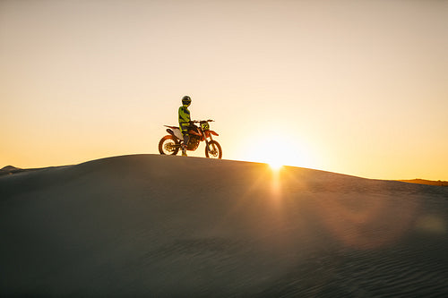 Motocross biker sitting on his bike