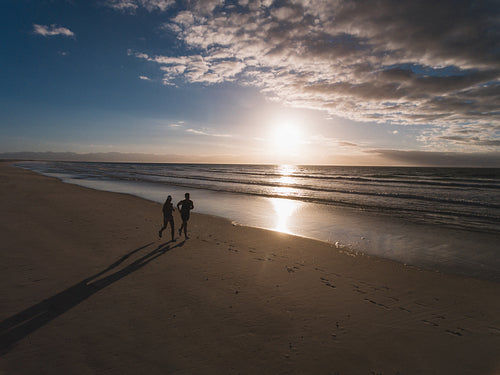 People running on the beach in morning