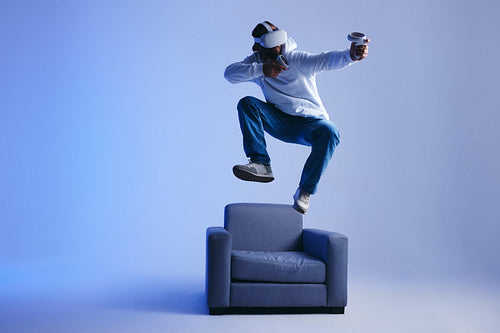 Energetic young man playing a virtual reality game