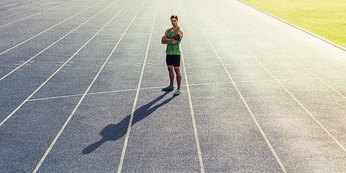 Sprinter standing on running track