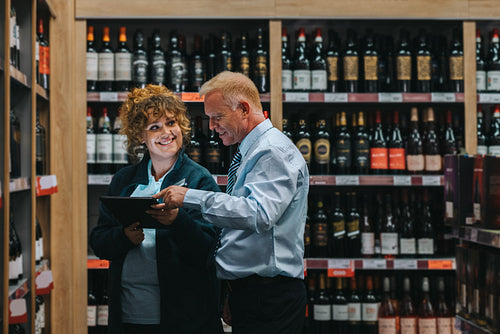 Liquor store workers taking stock