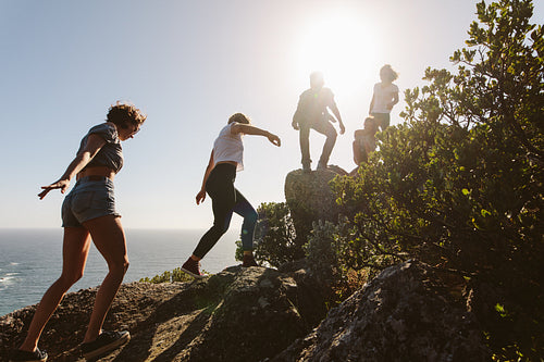 Young people on mountain hike on a summer day