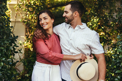 Smiling young couple embracing each other outdoors