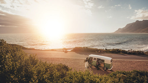 Friends on roadtrip travelling by a van