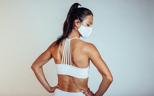 Woman in sportswear with protective face