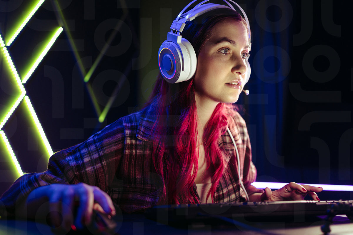 Gaming girl focusing on her computer screen as she takes on an online ...