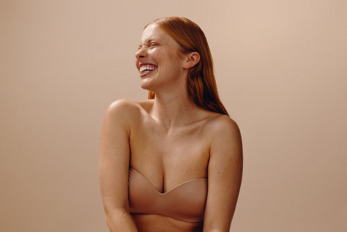 Wellness woman laughing with natural skin and relaxed posture