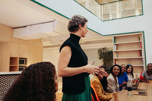 Group of diverse professionals engaged in a lively agency office meeting