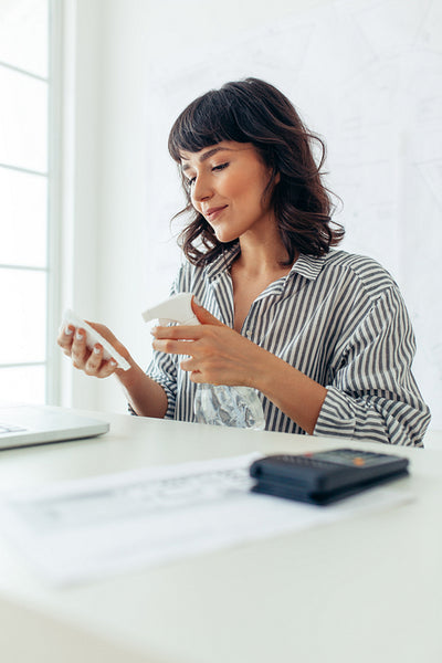 Woman spraying sanitizer on cloth