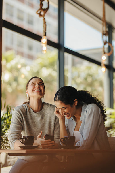 Female friends smiling in a cafe