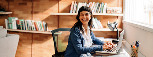 Businesswoman smiling while working from home