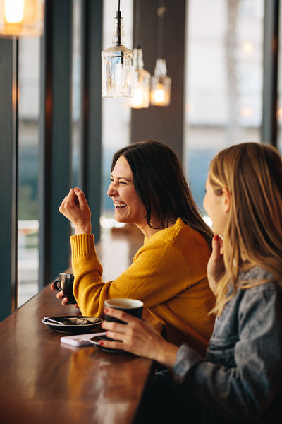 Women smiling in a coffee shop