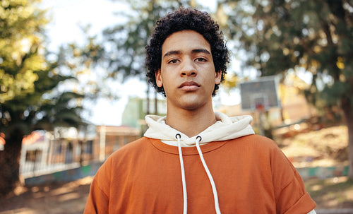 Teenage boy looking at the camera outdoors during the day