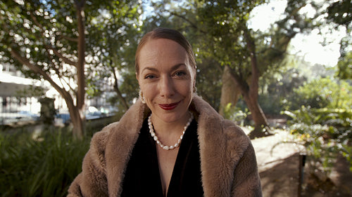 Wealthy senior woman smiling in the park
