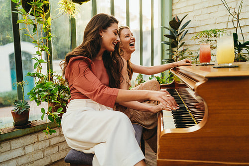 Tourist women having fun playing their favourite piano songs